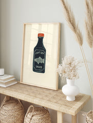 Illustrative print of a dark blue soy sauce bottle with a red cap, white 'LIGHT SOY SAUCE', in an alternate framed mockup