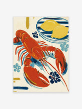 Red lobster and two lemons on a blue striped plate, with blue flower motifs on cream