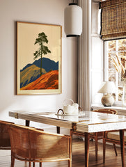 Graphic illustration of a lone pine tree on an orange hill with blue mountains, minimalist, in a styled room mockup