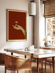 Illustration of a hand holding a lotus flower on a red background, traditional Indian art style, in a styled room mockup