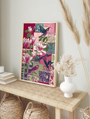 Illustrative collage print with pink magnolia flowers, various colourful birds, and patterned, in an alternate framed mockup