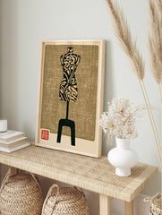 Mannequin wall art print with floral pattern and textured tan background in a woodblock style, in an alternate framed mockup
