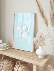 Illustrative manta ray with floral pattern and separate flower bouquet on light blue, in an alternate framed mockup