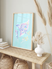 Illustrative manta ray wall art with floral pattern in pink, blue, yellow on light blue, in an alternate framed mockup