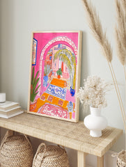 Vibrant illustrative print of a Moroccan archway interior with pink walls, palm tree, and, in an alternate framed mockup