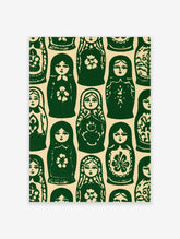 Repeating pattern of green and cream Matryoshka nesting dolls in a folk art illustrative style
