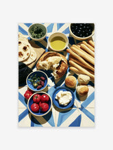 Mediterranean food still life print with bread, olives, tomatoes, and oil on blue tile background