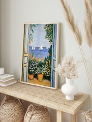 Vibrant Mediterranean sea view poster with open blue doors, potted white and orange flowers, and sailboats on blue water. - Image 4