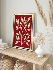 Minimalist botanical wall art with a cream-coloured leafy branch on a solid deep red, in an alternate framed mockup