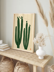 Minimalist cactus wall art with two green cacti on a cream background, illustrative botanical, in an alternate framed mockup