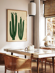 Minimalist cactus wall art with two green cacti on a cream background, illustrative botanical print, in a styled room mockup