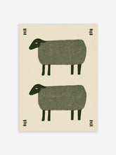 Minimalist folk art print featuring two stacked green sheep illustrations with small decorative dash patterns on cream