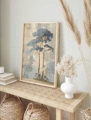 Illustrative misty forest landscape art print with tall blue-leafed trees and white-blossomed, in an alternate framed mockup