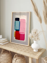 Abstract geometric wall art print with stacked rounded rectangular shapes in pink, blue, red, in an alternate framed mockup