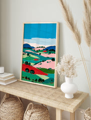 Vibrant modern landscape wall art painting featuring rolling hills, fields, and trees in bold blue, green, pink, and red colors under a blue sky. - Image 3