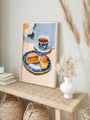 Watercolor illustration of a mooncake and teacup on a blue patterned plate with a white peony, in an alternate framed mockup