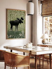 Moose illustration print, black silhouette moose in green water, white stylised trees and plants, in a styled room mockup