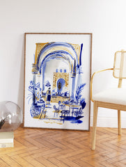 Moroccan interior wall art illustration in blue and gold, depicting a cafe scene with arches, tables, and a person. - Image 2