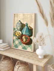 Moroccan kitchen art print with a blue tagine, lidded pot, lemons, and food on a green checkered tablecloth. - Image 3