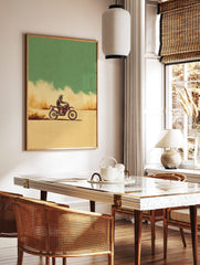 Illustrative motocross dirt bike rider on a red bike, kicking up dust in a beige desert under a, in a styled room mockup