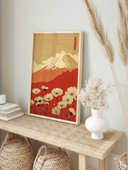 Illustrative print of Mount Fuji with snow, red hills, white cosmos flowers, beige sky, and, in an alternate framed mockup