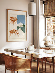 Japanese landscape art print with Mount Fuji, a traditional house, and orange bamboo branches on a, in a styled room mockup