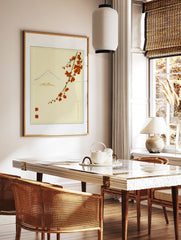 Japanese-style Mount Fuji illustration with red blossoms and red stamps on a cream background, in a styled room mockup