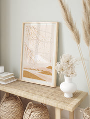 Japanese-style wall art print with gold Mount Fuji and white cherry blossoms on a soft beige, in an alternate framed mockup