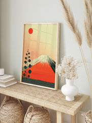 Mount Fuji in red with white snowcaps, a red sun, and a tall stylised plant on a textured, in an alternate framed mockup
