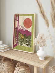 Illustrative Mount Fuji art print with magenta mountain, red sun, pine trees, and green, in an alternate framed mockup