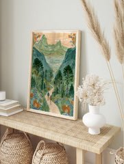 Illustrative mountain valley scene with two hikers on a path and large orange flowers in the, in an alternate framed mockup