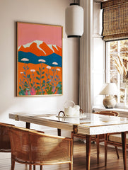 Stylised mountain landscape art print with orange peaks, white snow, blue lake, and white yarrow, in a styled room mockup