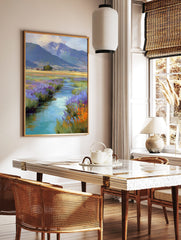 Impressionistic painting of a winding stream with purple and orange wildflowers leading to, in a styled room mockup