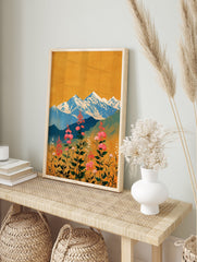 Vibrant mountain wall art featuring pink flowers in a meadow with blue snowy peaks and a golden yellow sky in an illustrative style. - Image 3