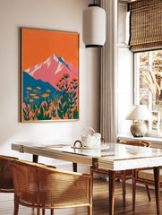Vibrant mountain wall art with pink peaks, orange sky, teal hills, and foreground of orange botanical flowers and green leaves. - Image 2