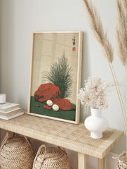 Japanese still life print of white mushrooms, reddish-brown rocks, and green grass on a, in an alternate framed mockup