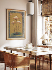 Botanical illustration of three ornate mushrooms with speckled caps and pink gills, framed by a, in a styled room mockup