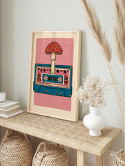 Retro cassette tape illustration with a red mushroom and floral pattern on a pink background, in an alternate framed mockup