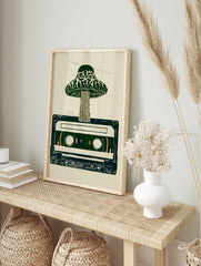 Mushroom sprouting from a retro cassette tape, illustrative art print in green and cream, in an alternate framed mockup