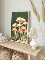 Illustrative print of cream and reddish-brown mushrooms with green foliage on a dark green, in an alternate framed mockup
