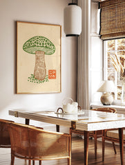 Green mushroom woodcut print with mottled cap and brown stem, orange Japanese character seal on, in a styled room mockup
