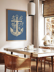 Decorative nautical anchor illustration art print with botanical leaves, flowers, and berries on a, in a styled room mockup