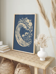 Stylised cream ocean wave with botanical flowers and leaves on a deep blue background, in an alternate framed mockup