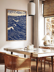 Illustrative blue ocean waves with white crests, a distant tree-lined coast, and striped sky art, in a styled room mockup