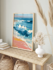 Impressionist painting of blue ocean waves crashing onto a peach and yellow sandy beach with, in an alternate framed mockup