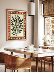 Botanical olive branch illustration with red berries and a decorative geometric border on a cream, in a styled room mockup