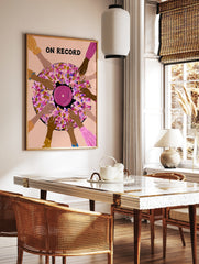 Illustrative wall art of a vinyl record surrounded by hands with ON RECORD text in pink, purple, in a styled room mockup
