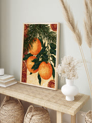 Illustrative botanical wall art of three hanging oranges on a pine branch with decorative, in an alternate framed mockup