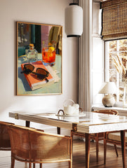 Orange cocktail art poster featuring a vibrant painting of a drink, sunglasses, and a book on a cafe table. - Image 2