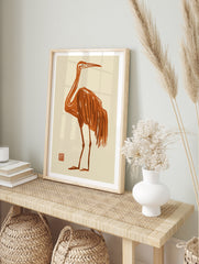 Minimalist orange crane bird illustration with Japanese-style brush strokes on a cream, in an alternate framed mockup